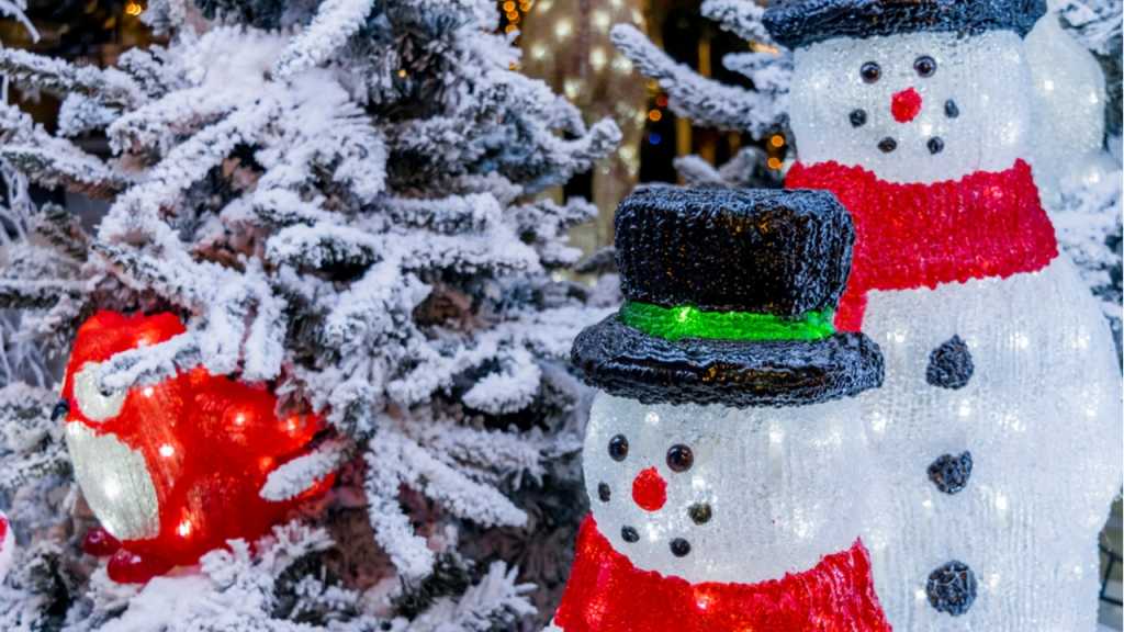 Leuchtende Schneemänner und Weihnachtsmann im Schnee