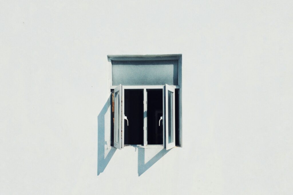 Geöffnetes Fenster in weißer Hauswand